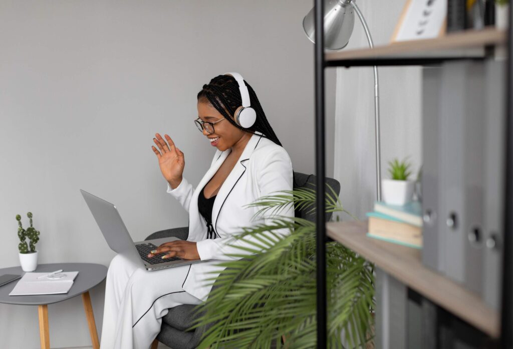 A professional South African woman working remotely on a laptop, illustrating gender-neutral parental leave benefits managed by DNA EOR.